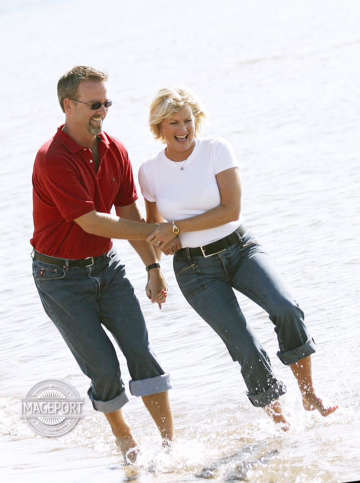 Stock Photo of couple having fun walking on the beach